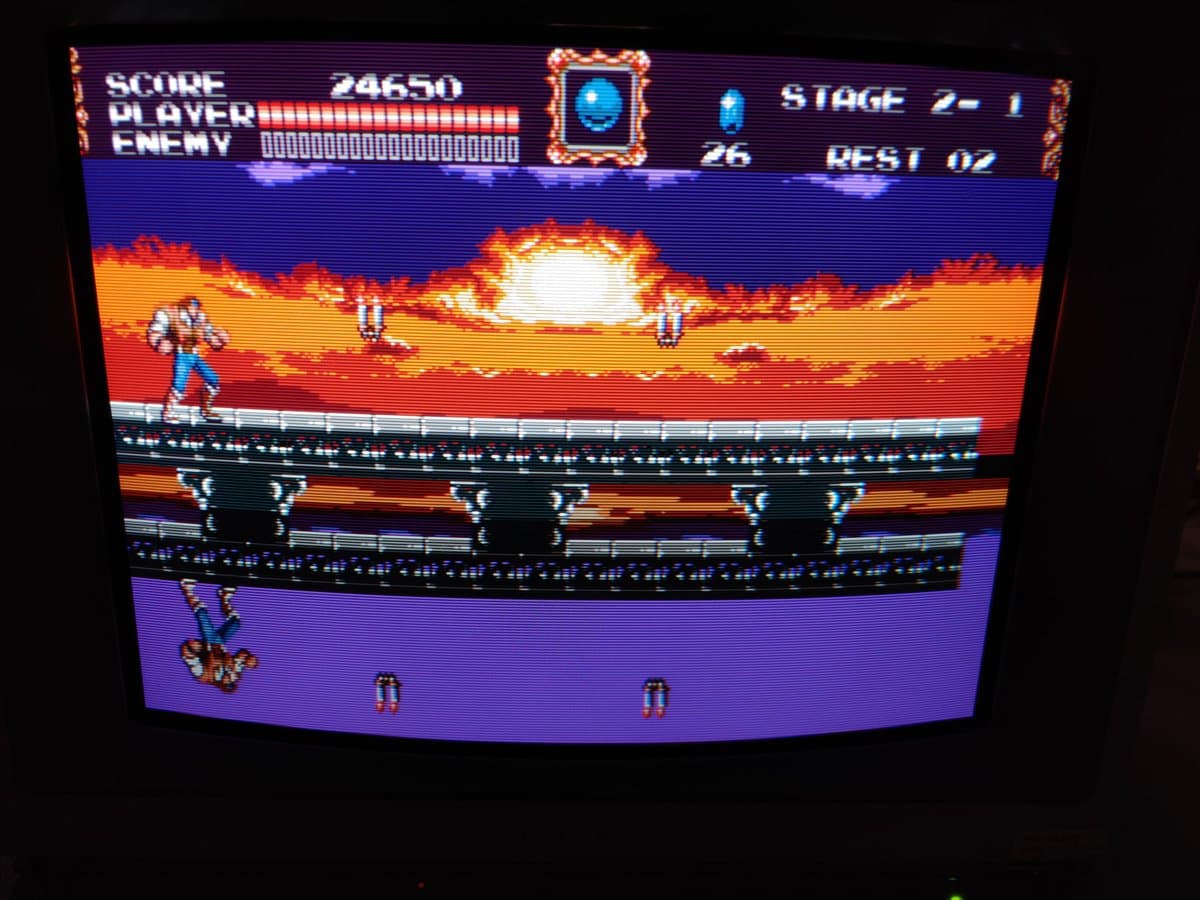 Sony PVM-14L2 displaying Castlevania gameplay; neck board recapping and anode cap maintenance in progress on professional monitor.