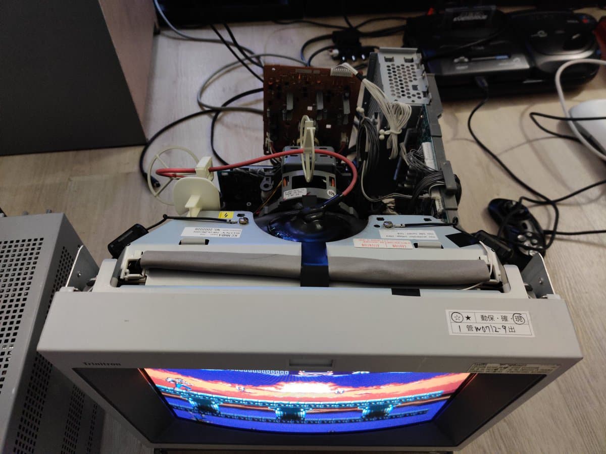 Sony PVM-14L2 with open chassis showing neck board recapping work, anode cap, and internal components during maintenance.