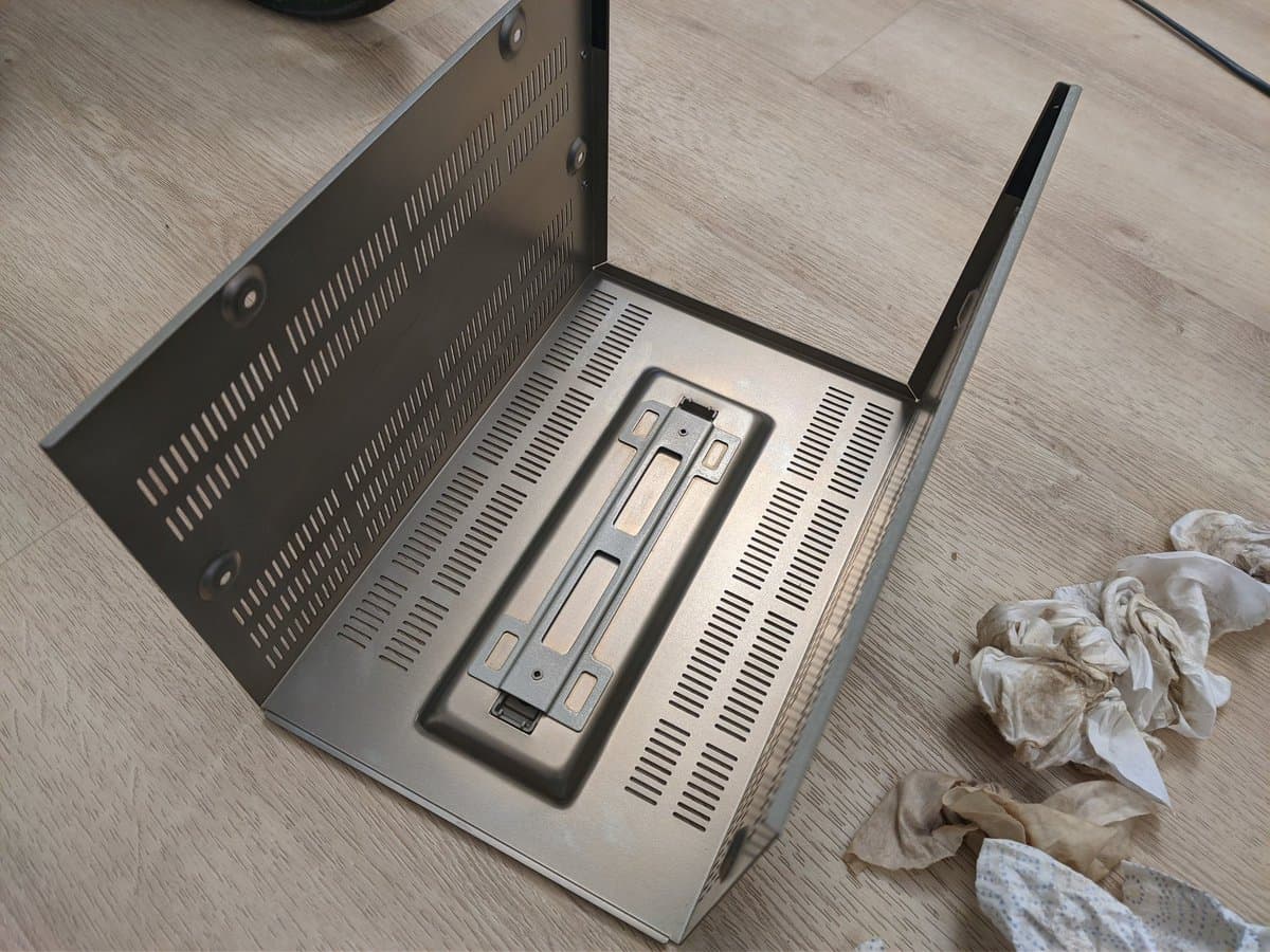 Sony BVM-9045QD opened showing yellowed chassis with heavy nicotine and dust accumulation inside, restoration in progress on wooden workbench.