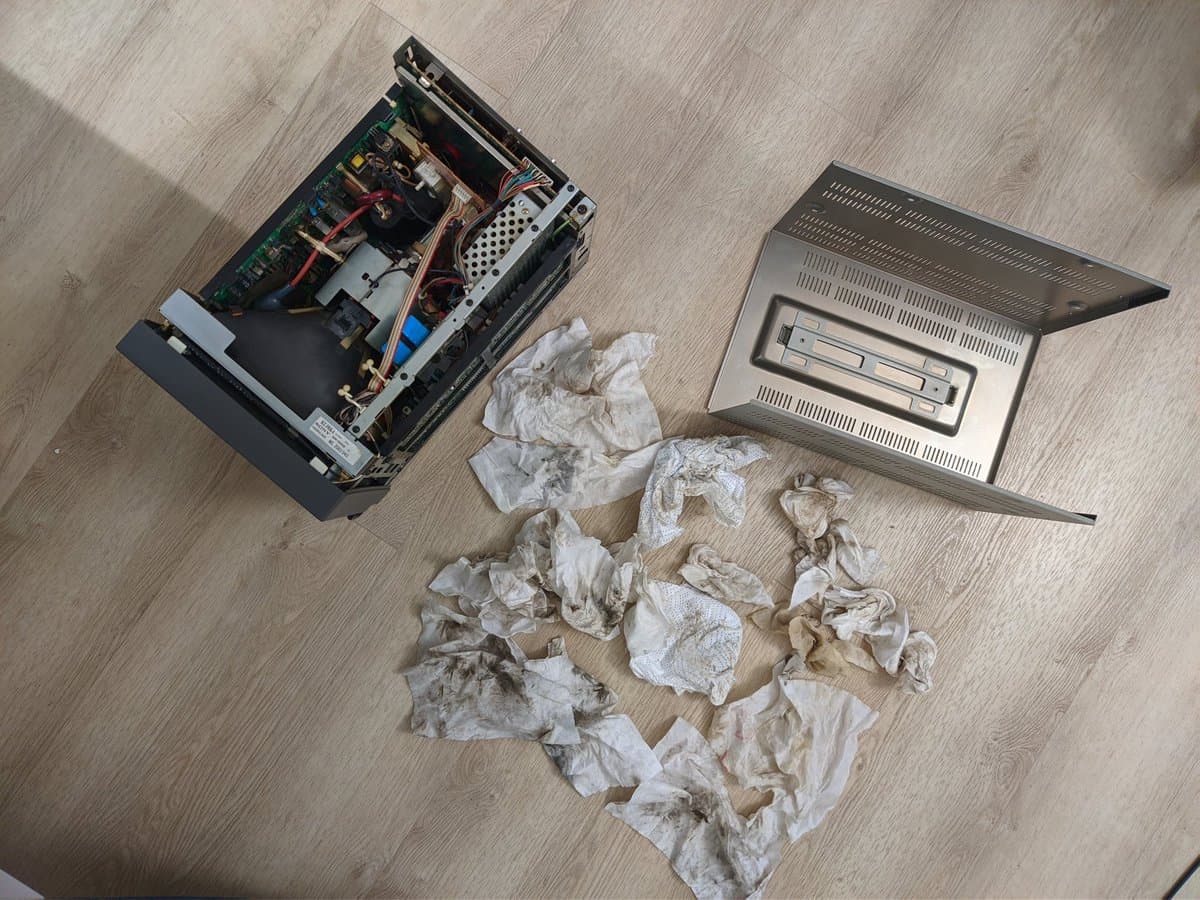 Disassembled Sony BVM-9045QD showing yellowed capacitors and nicotine-stained internal components alongside removed deflection board and PSU during restoration.