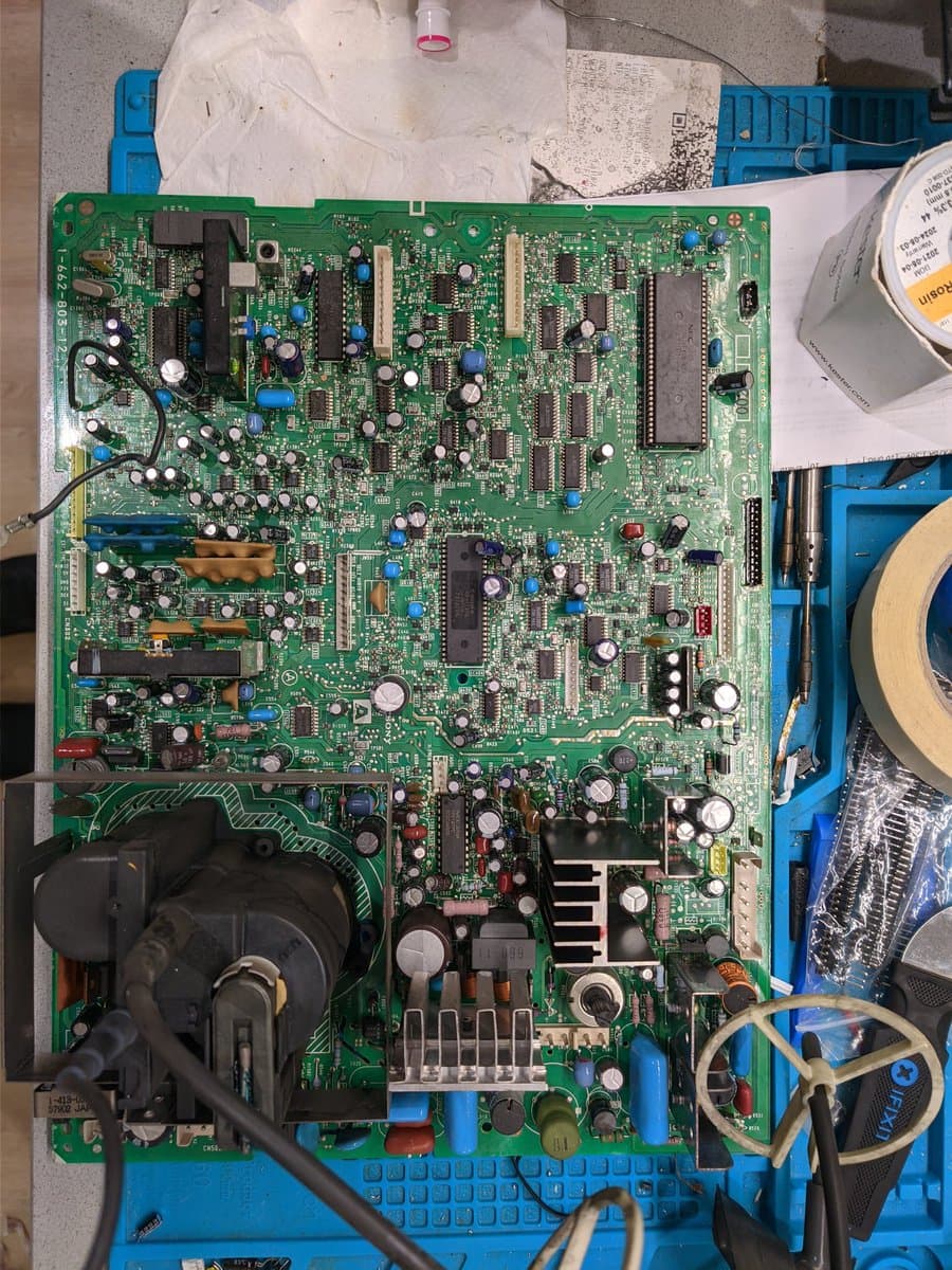 Sony PVM-14M4J main board during retrace line repair, showing Savon Pat capacitor kit replacement work in progress on blue power supply section.