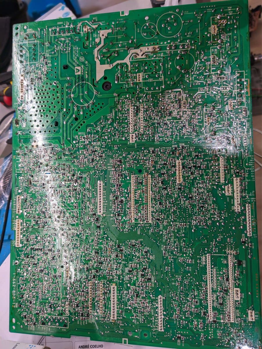 Sony PVM-14M4J A board showing reflowed solder joints; white dots mark replaced capacitors across the densely populated circuit board.