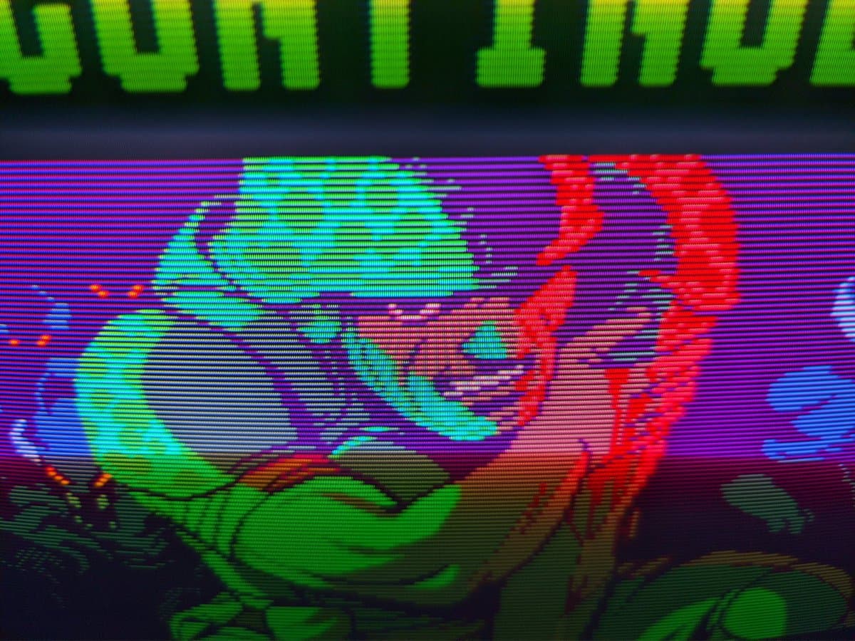 Sony PVM-14M4J displaying colorful test pattern with cyan, red, and green gradients; retrace lines visible across screen after repair.