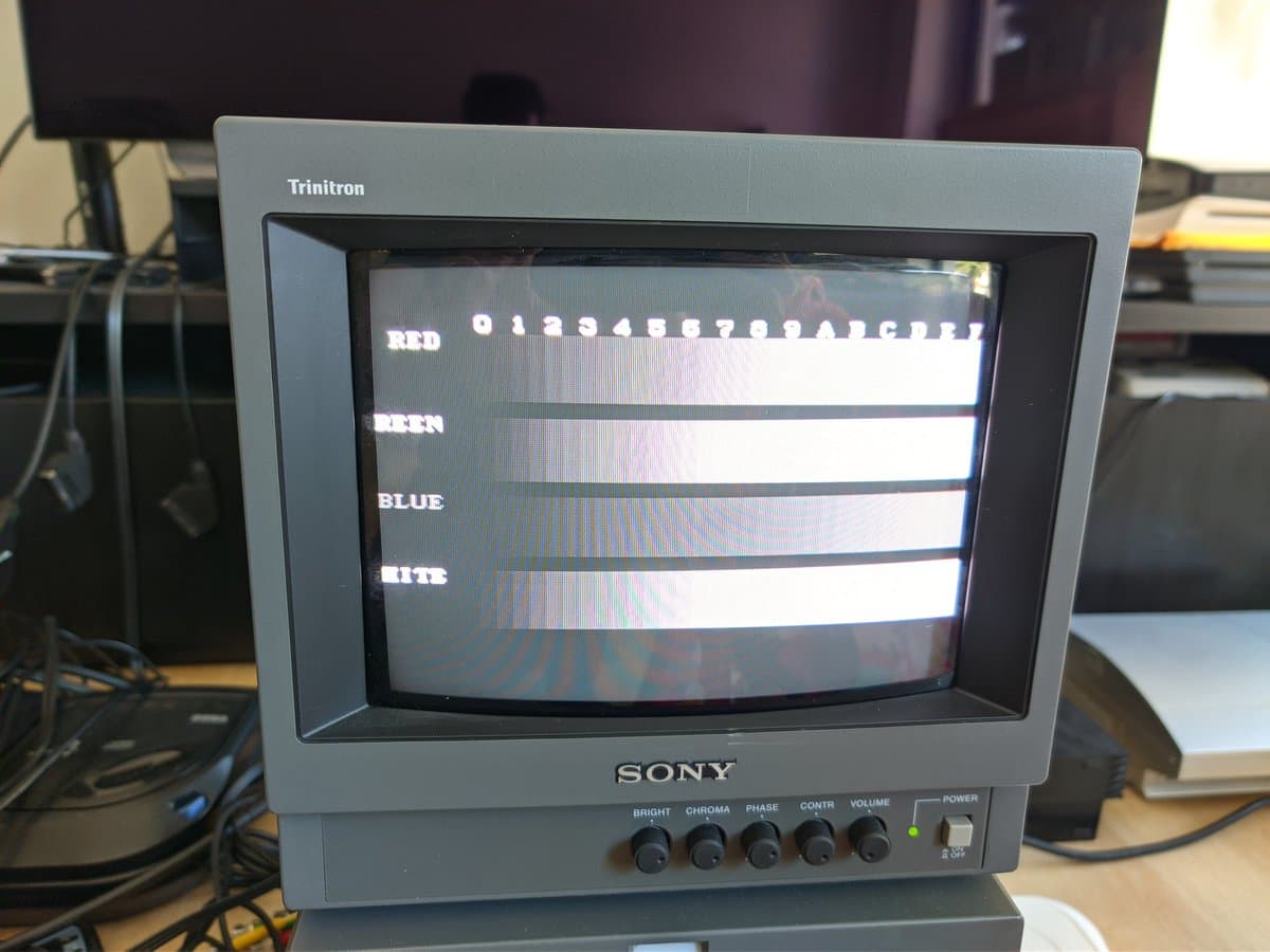 Sony PVM-9040 CRT displaying color bars test pattern showing RED, GREEN, BLUE, and WHITE channels for diagnostics.