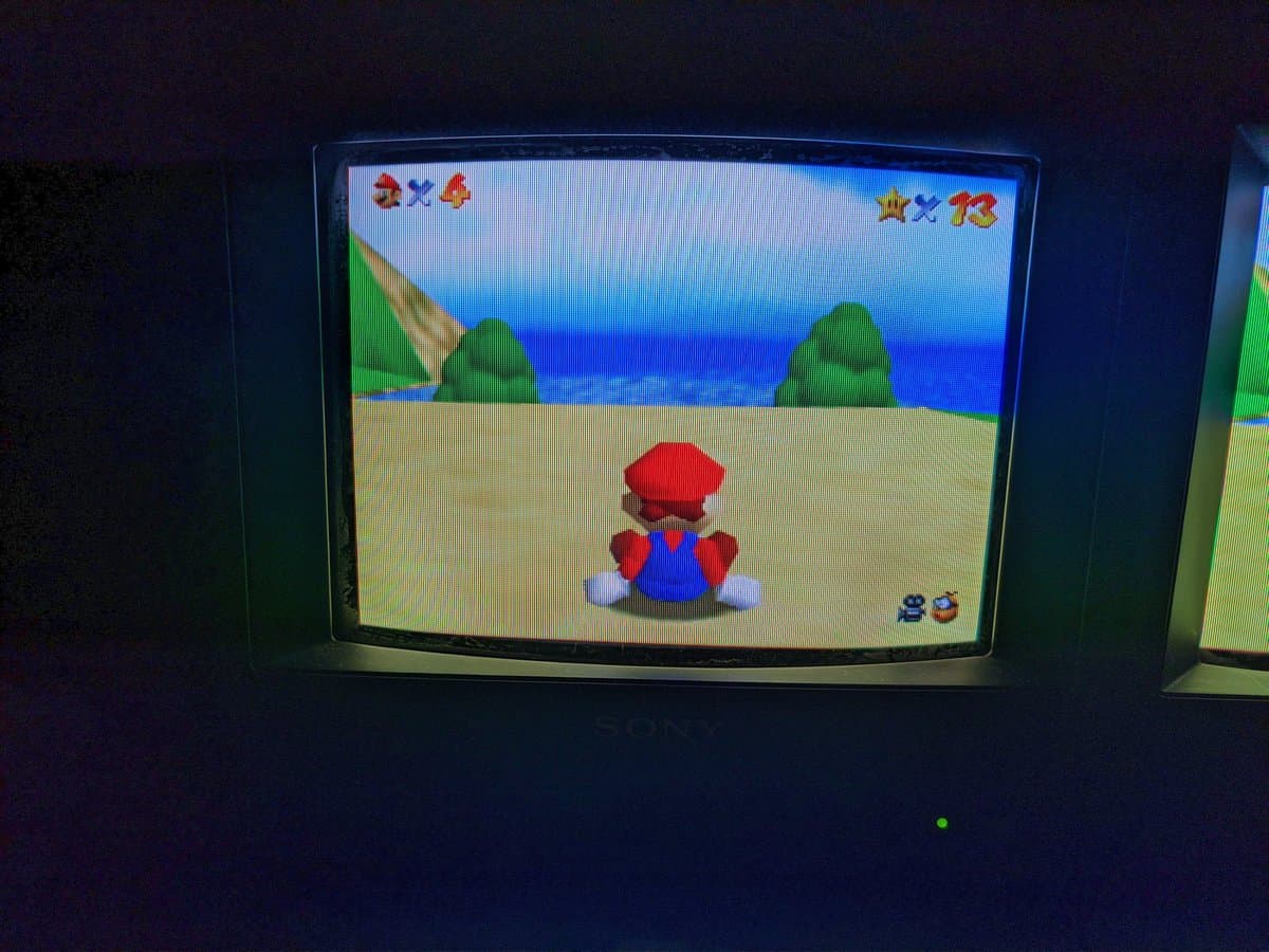Sony BVM-9045QD displaying Mario character on beach; restored after missing color channel and neckboard repair.