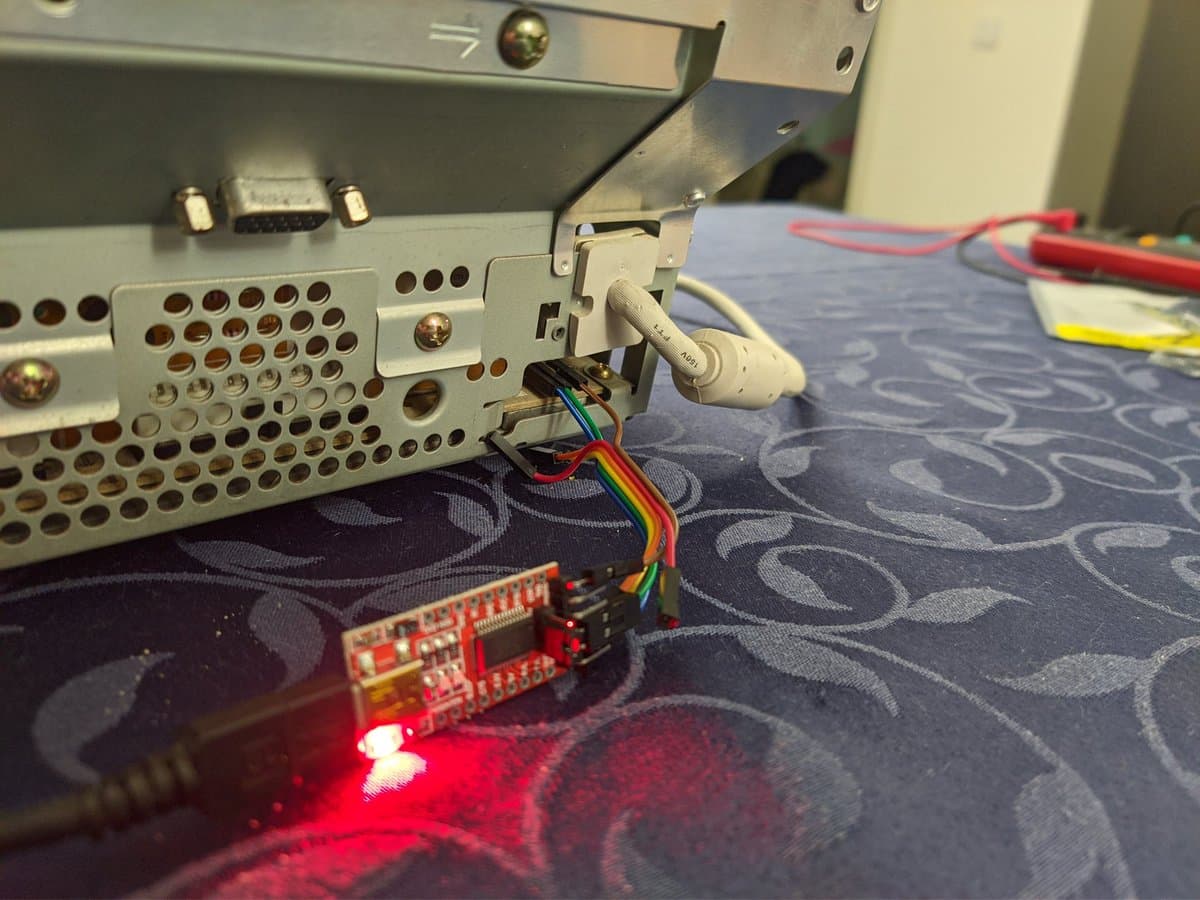USB-to-serial TTL adapter with rainbow wire connected to Sony CPD-G420 CRT monitor for G2 voltage calibration via WinDAS software.