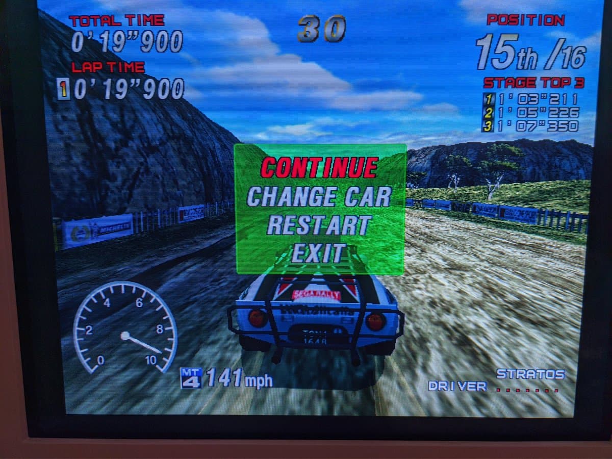 Sega Rally arcade racing game paused mid-race on Sony CPD-G420 CRT, displaying menu options and HUD with speedometer and lap times.