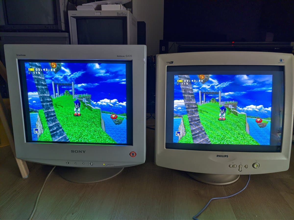 Two CRT monitors displaying identical Sonic Adventure gameplay; Sony G420 on left, Philips on right, demonstrating geometry correction post-repair.
