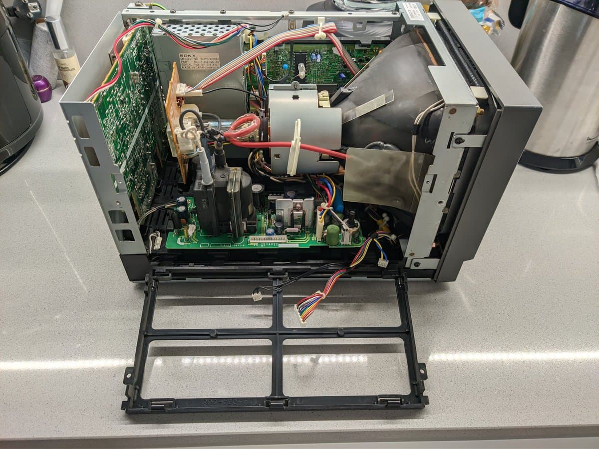 Sony PVM-9040 deflection board exposed during recap maintenance, showing capacitors, wiring, and internal circuitry from above.