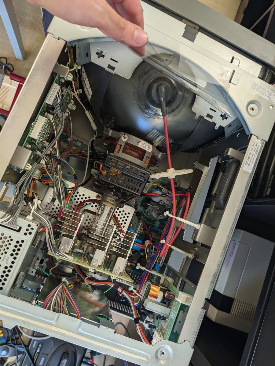 Interior view of BVM-D14H1E with top panel open, showing capacitor kit installation in progress among circuit boards and wiring.