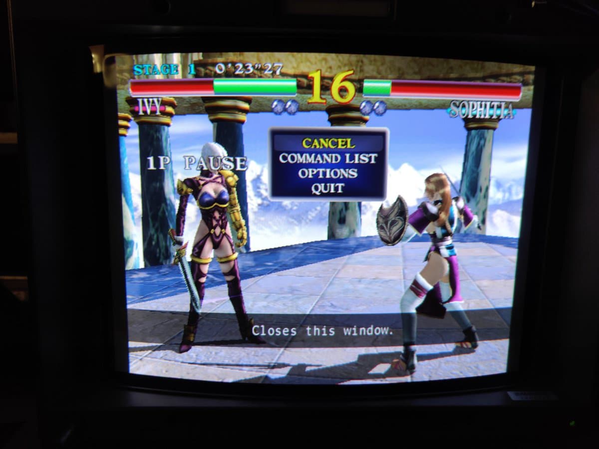 Fighting game in progress on Sony BVM-D14H1E CRT monitor, pause menu visible, demonstrating restored Dreamcast 480p RGB output via Extron 109xi scaler.