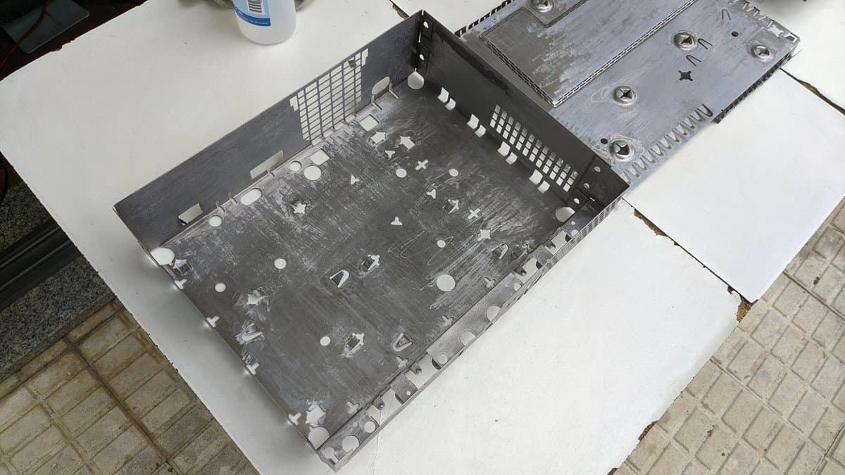 Disassembled OG Xbox motherboard showing corrosion damage, capacitors, and component layout during refurbishment restoration process.
