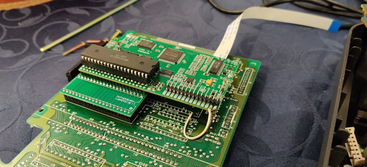 NESRGB board installed in Twin Famicom with wireless mod kit and Jeff Chen's diamond accessory mounted on motherboard stack.