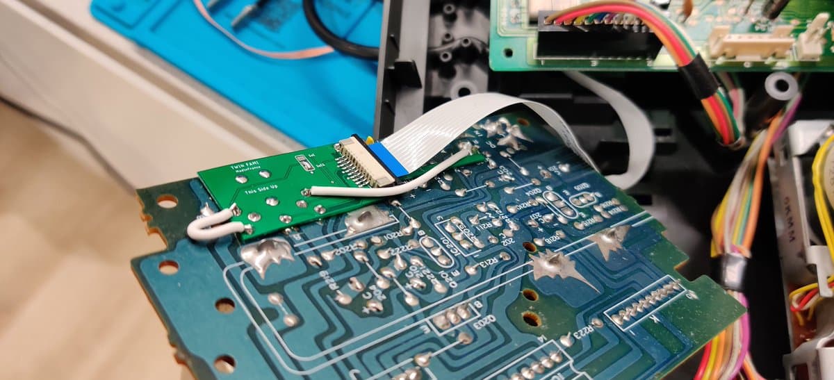 NESRGB board installed in Twin Famicom with ribbon cable connection and wireless mod kit integrated during upgrade.