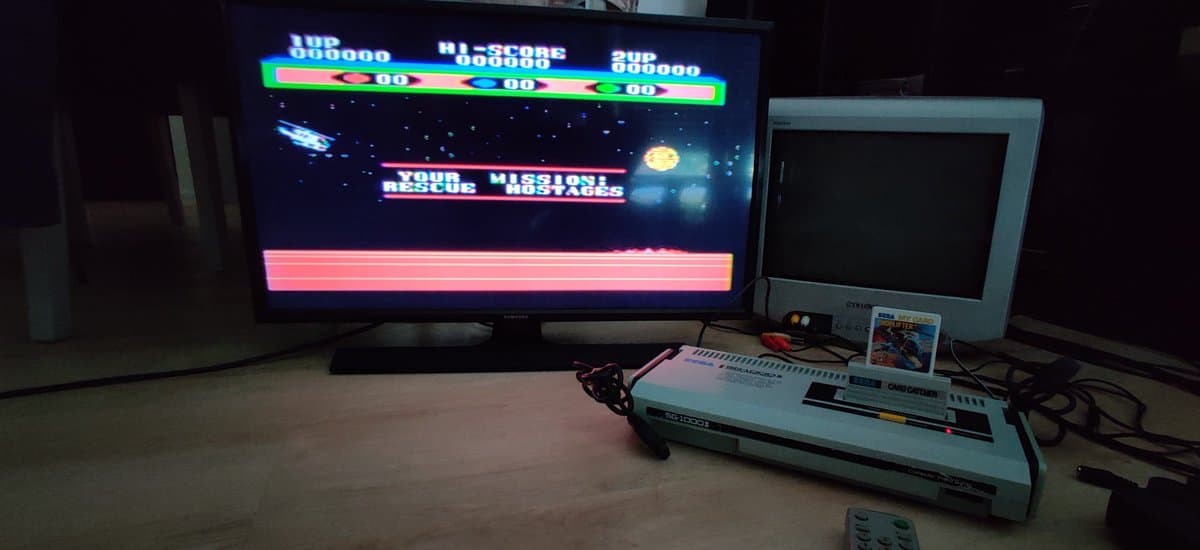 Sega SG-1000 II displaying "Your Mission: Rescue" game on CRT monitor after recap repair, showing composite output during testing.