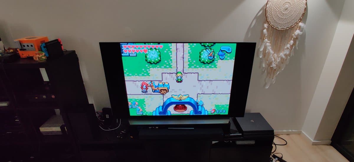 Spice orange GameCube displaying Kirby Super Star Ultra gameplay on TV, showing console restoration setup with gaming environment.