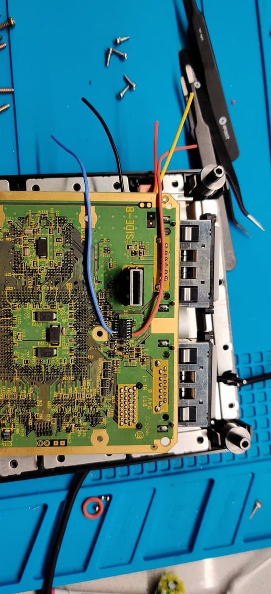 GameCube PAL DOL-101 mainboard with PicoBoot mod in progress, showing WiiKey interface, wired connections, and scattered screws on blue work mat.