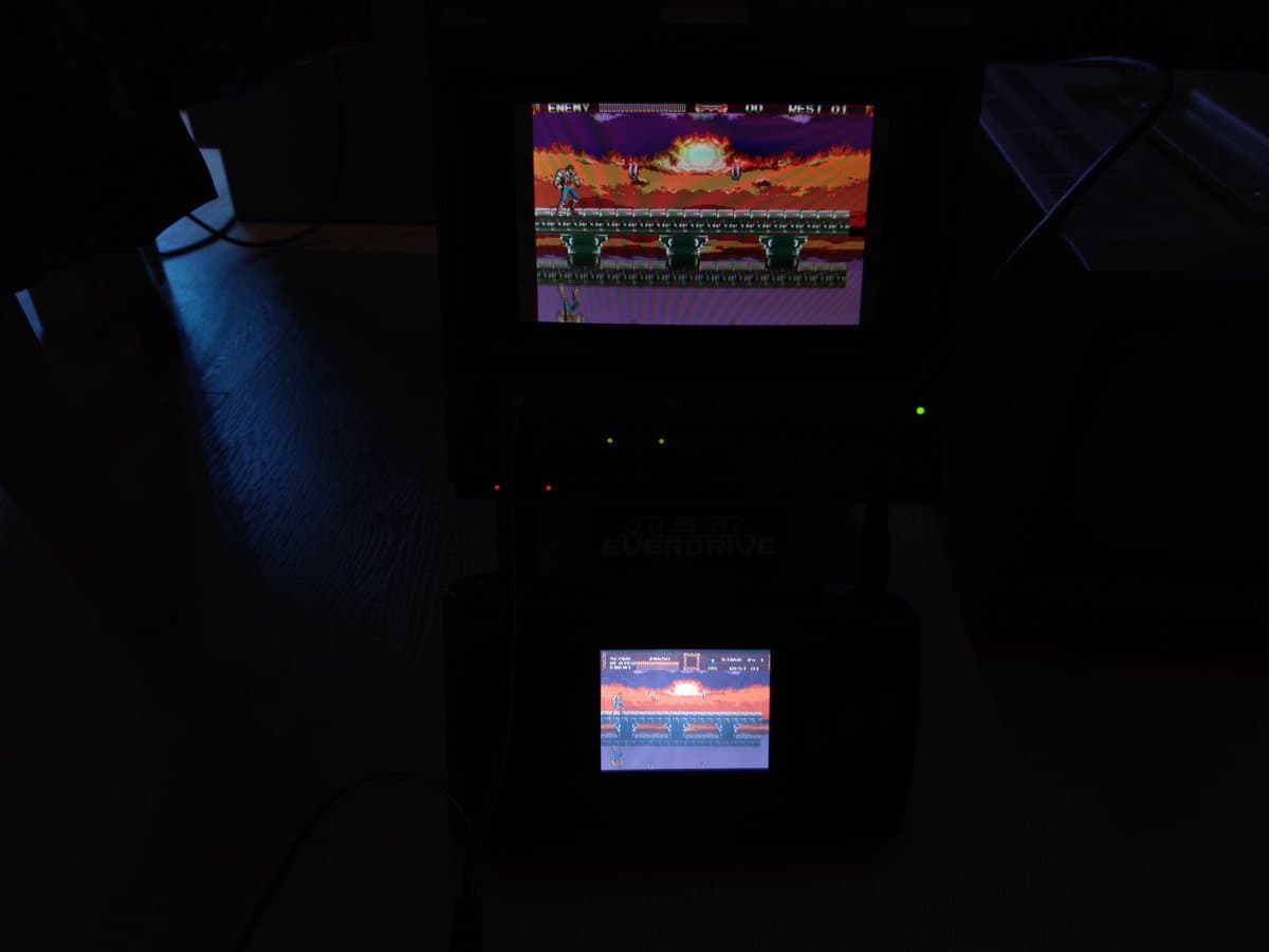 Sega Nomad displaying Castlevania gameplay on two screens during restoration testing after capacitor replacement.