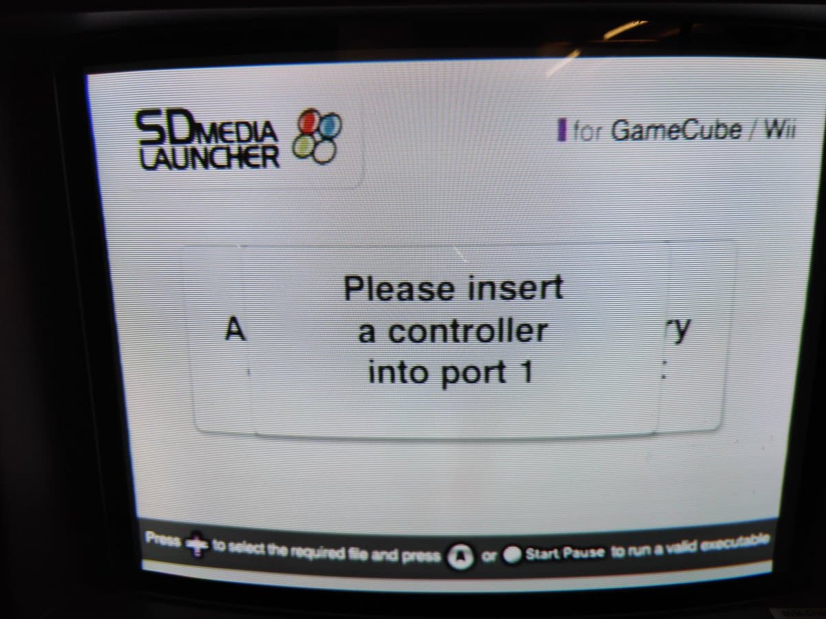 SD Media Launcher menu on GameCube, prompting controller insertion into port 1 after mainboard capacitor replacement repair.