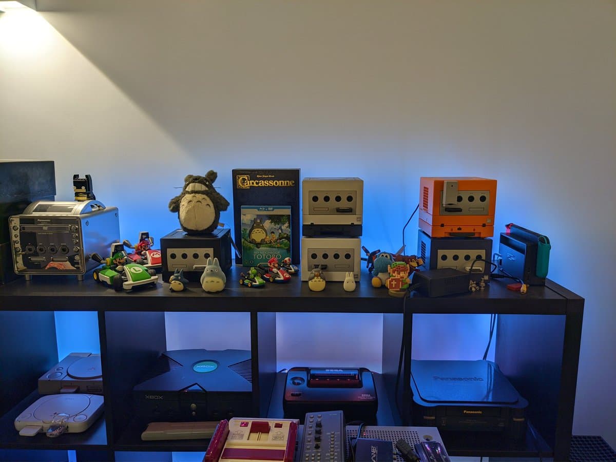 Silver GameCube with recapped mainboard displayed among restored GameCube fleet, Tetris blocks decoration visible.