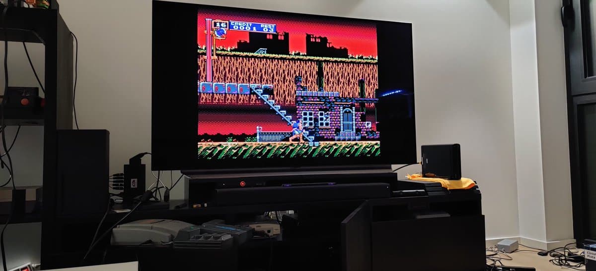 NEC PC Engine Super CD-ROM2 displaying Castlevania on TV; console on black stand with 8-pin DIN and RGB amp modifications visible.