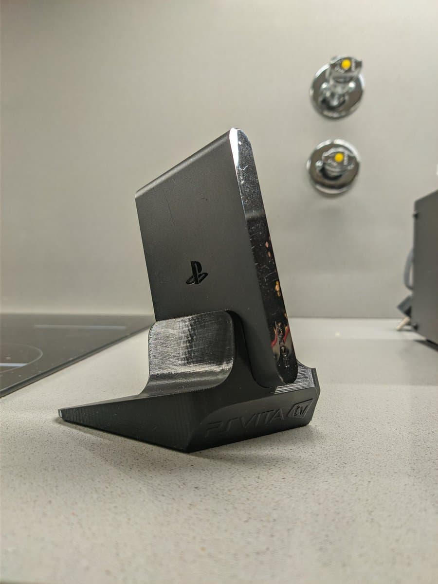 Black PS Vita TV on Jeff Chen 3D-printed stand, cleaned and ready for use after CFW installation and restoration.