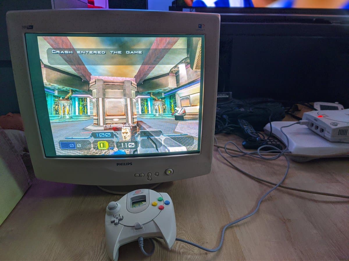 Philips 109S4 CRT displaying Dreamcast gameplay with VGA dongle connected; white Dreamcast controller in foreground shows monitor's picture quality before warm-up.