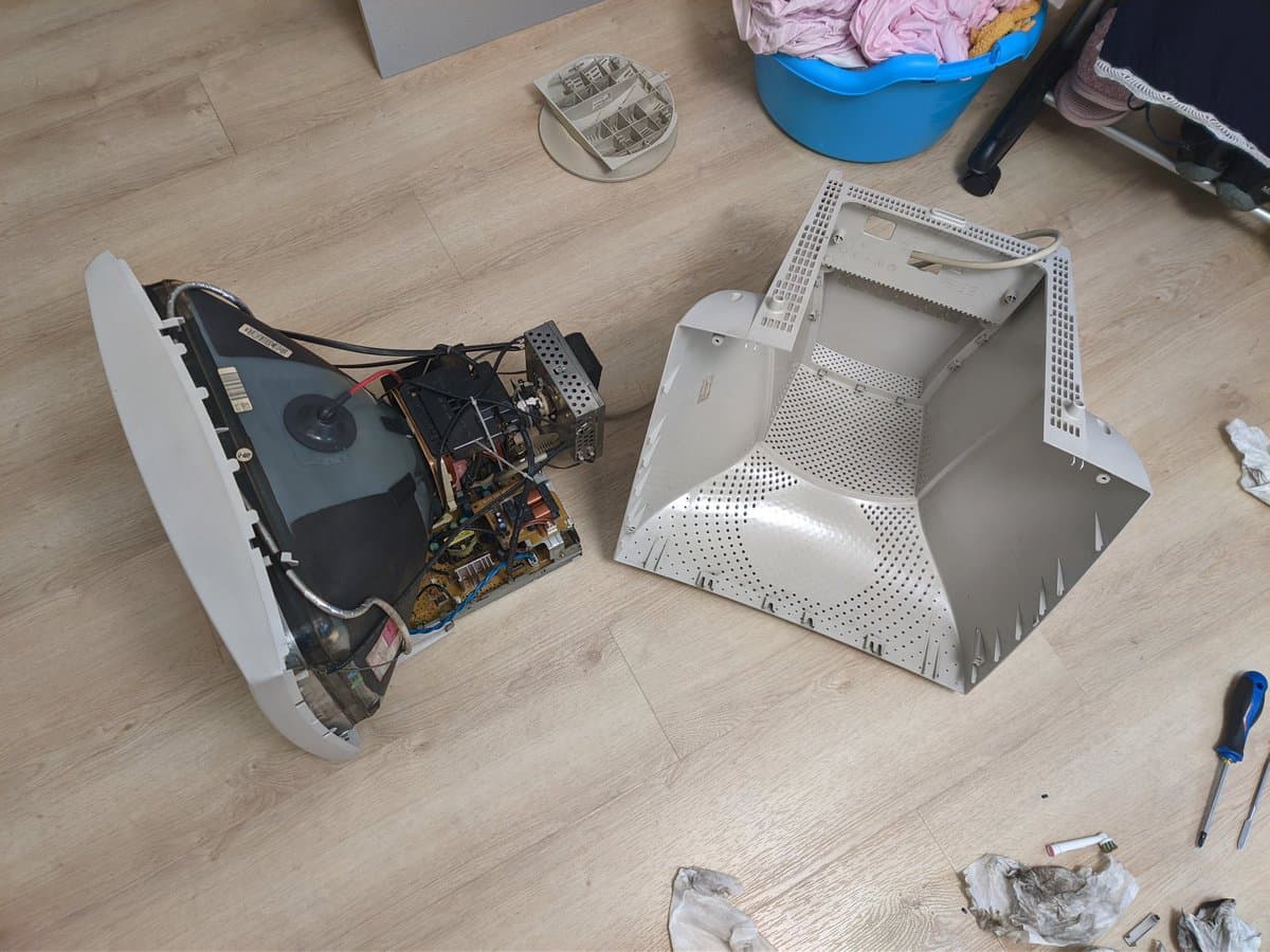 Disassembled Philips 109S4 CRT monitor showing internal PCBs with Capxon capacitors, deflection coils, and power supply components during restoration work.