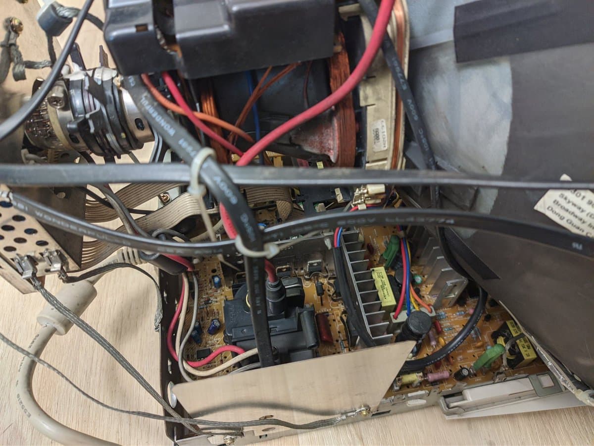 Interior of Philips 109S4 monitor showing power supply PCB with Capxon capacitors, transformer, and wiring during restoration work.