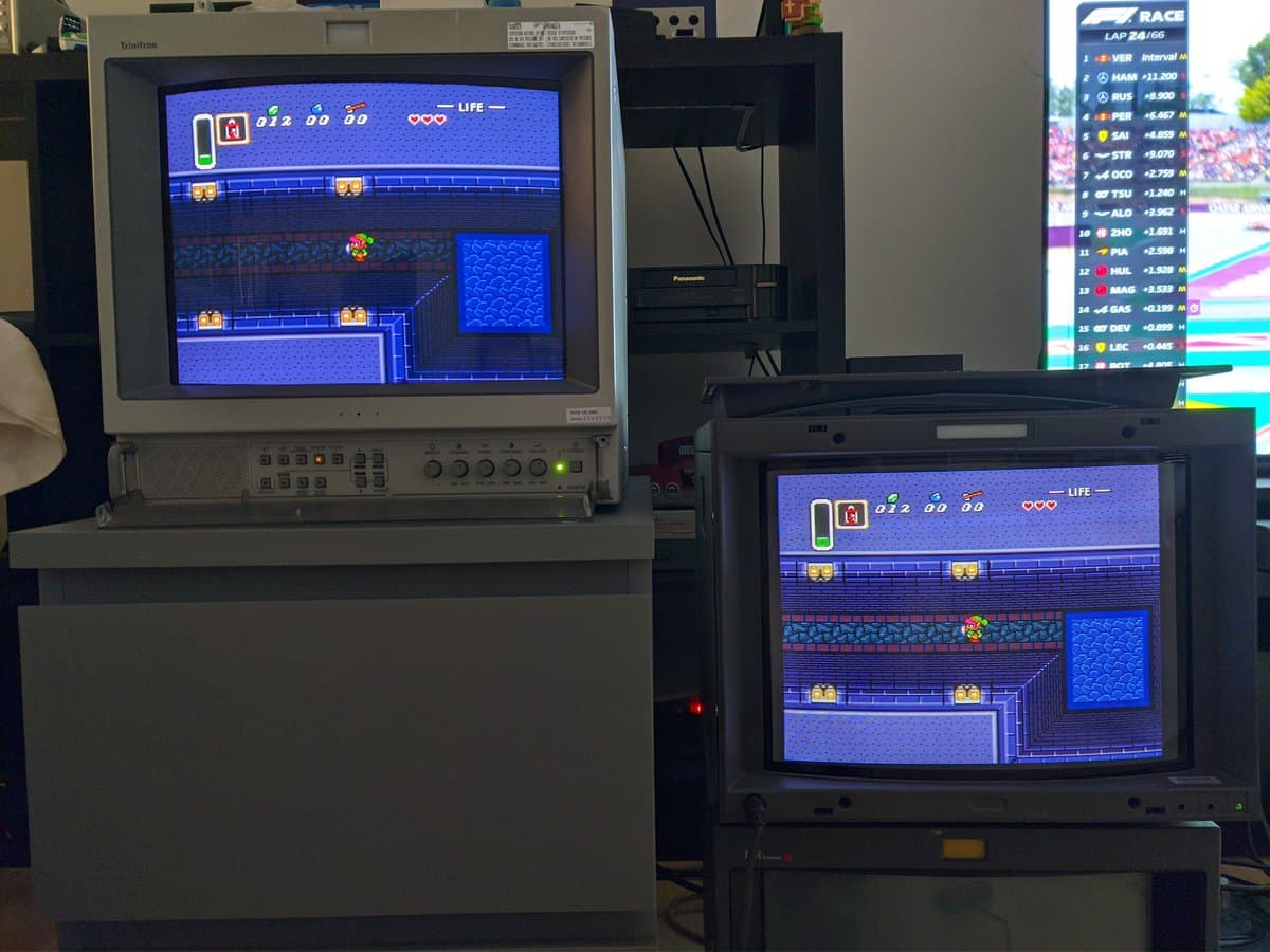 Two Sony PVM-14L2 CRT monitors daisy-chained displaying Sonic the Hedgehog gameplay, demonstrating monitor connectivity and functionality during maintenance testing.