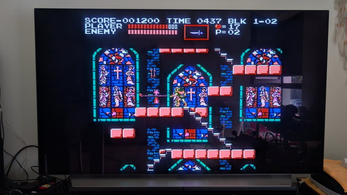 AV Famicom running Castlevania after cartridge slot cleaning and full recap; game boots successfully with score display.
