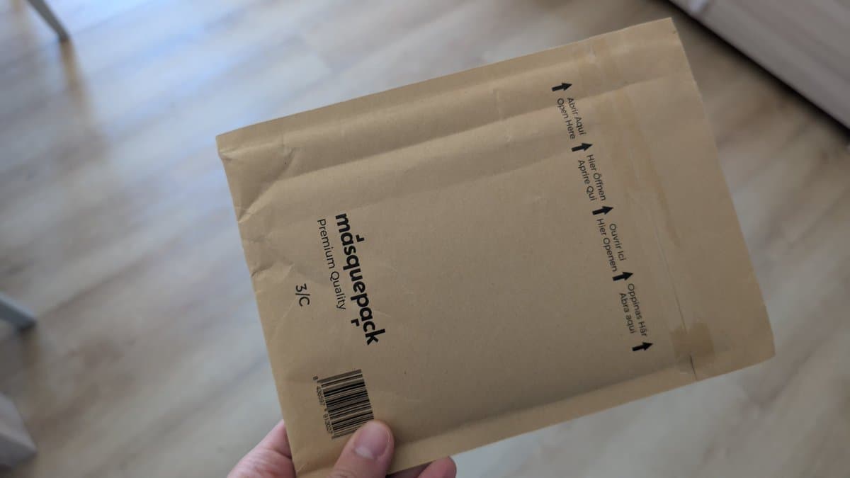 Bubble mailer package held in hand with barcode visible, labeled "mdsbuyppack Premium Quality" for Super Famicom Jr. upgrade components.