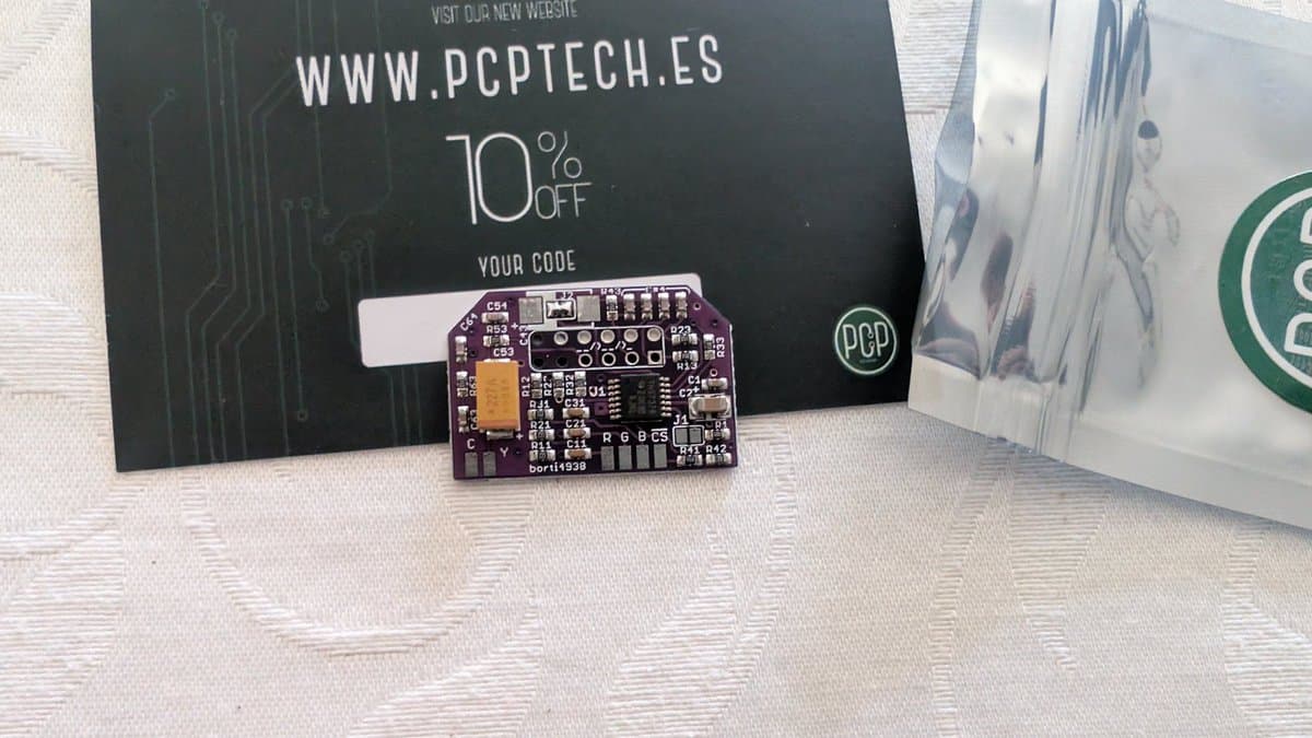 Purple circuit board with yellow capacitor and labeled components next to PCP Tech promotional card with 10% discount code.