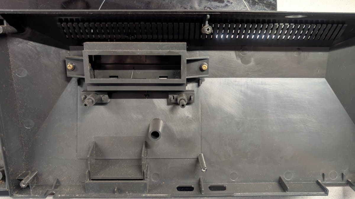 Sega Master System MK-2000 interior showing cartridge slot, RF shield, and motherboard mounting points during disassembly for refurbishment and cleaning.