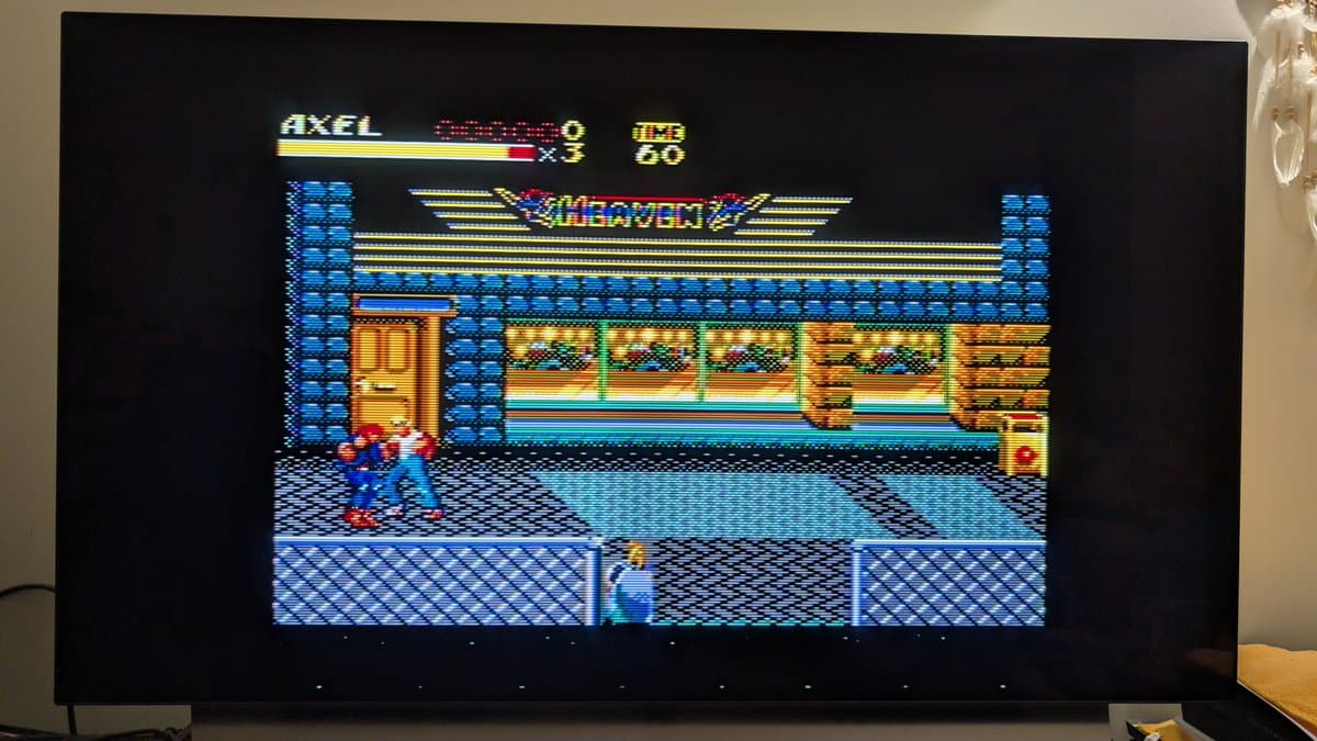 Alex Kidd in Miracle World running on refurbished Master System MK-2000, displaying vibrant 8-bit graphics with player character on screen.