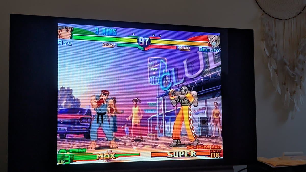 Street Fighter Alpha 3 gameplay on Dreamcast showing Ryu vs Deejay match, testing controller input after PSU recap refurbishment.