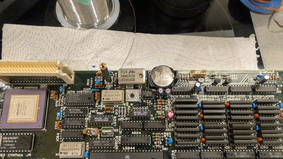 Recapped X68000 main board with new oscillator installed, CR2032 battery mod, cleaned IC sockets and solder joints visible.