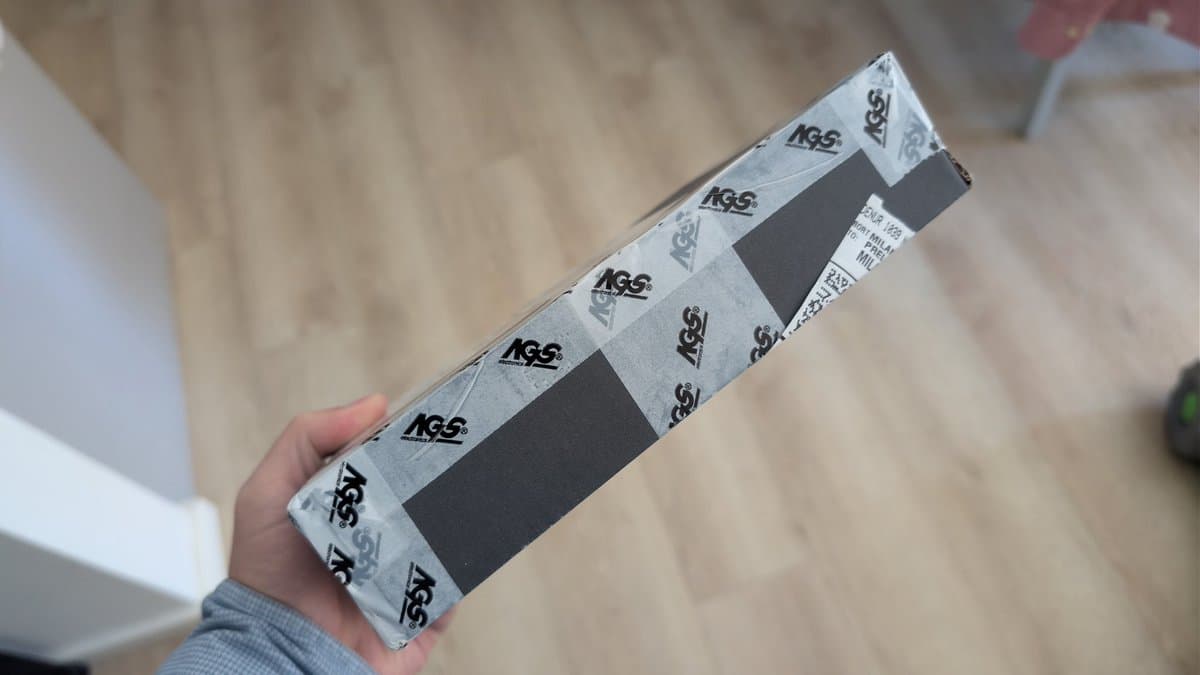 KSS-240A optical pickup still in packaging, held in hand before installation in Mega-CD model 1.