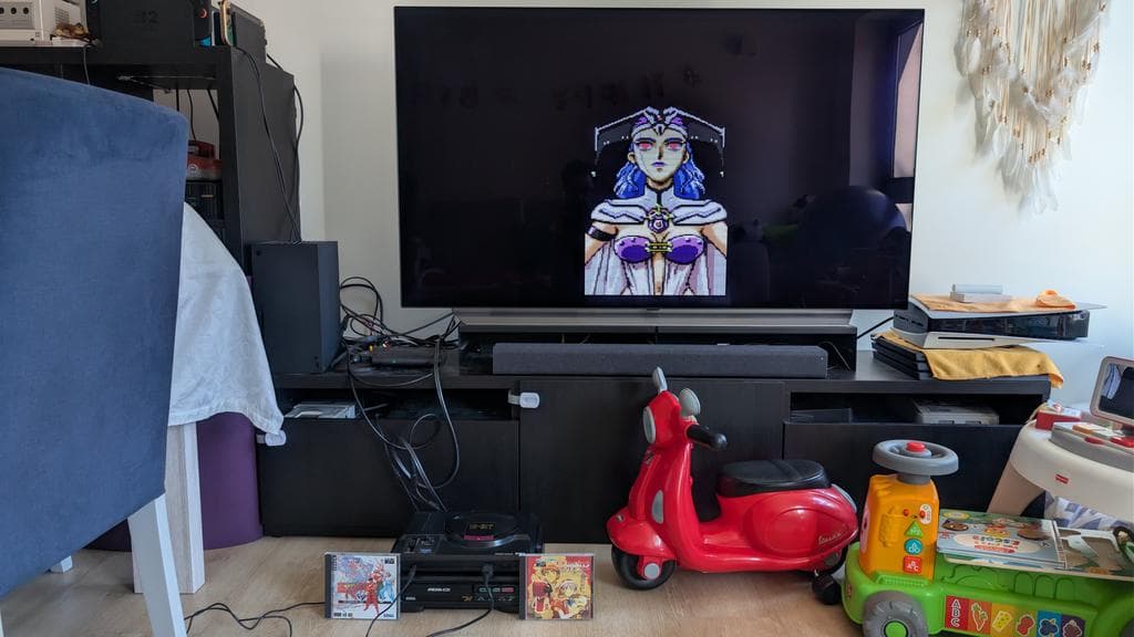 Sega Mega-CD 1 console displayed on entertainment center with Final Fight and Lunar game cases nearby, ready for restoration work.