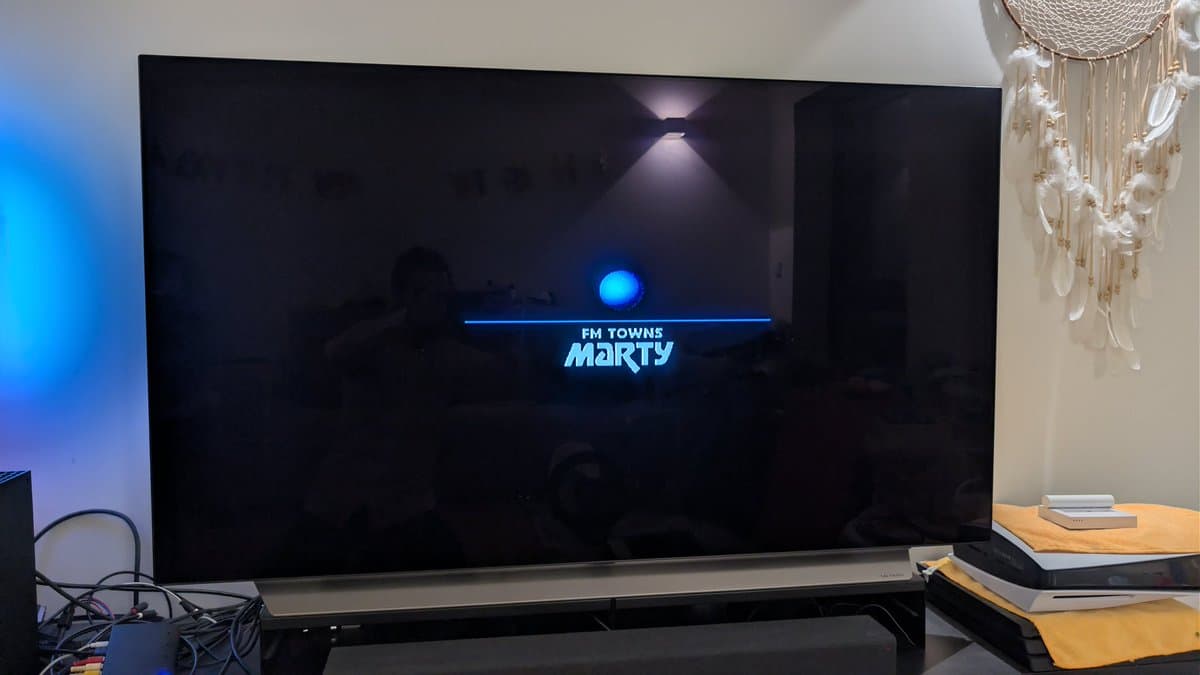 FM Towns Marty startup screen displaying blue "FM TOWNS marty" text on black background, indicating successful boot after restoration.