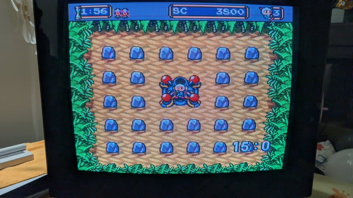 Bomberman '94 gameplay on NEC PC Engine, showing blue bombs on wooden floor with red character in center, validating IFU-30 recap repair.