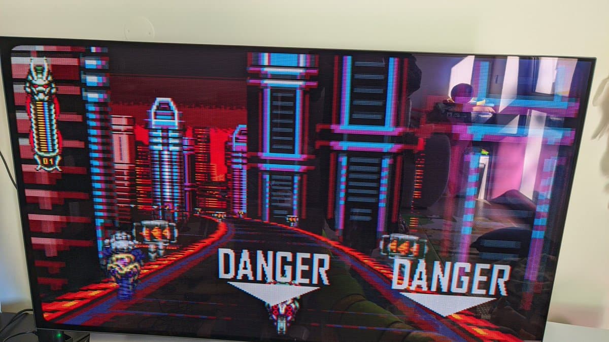 Vengeful Guardian: Moonrider gameplay on restored Sony BVM-D14H1E professional CRT monitor, displaying neon-lit cyberpunk level with "DANGER" warnings and pixel art character.
