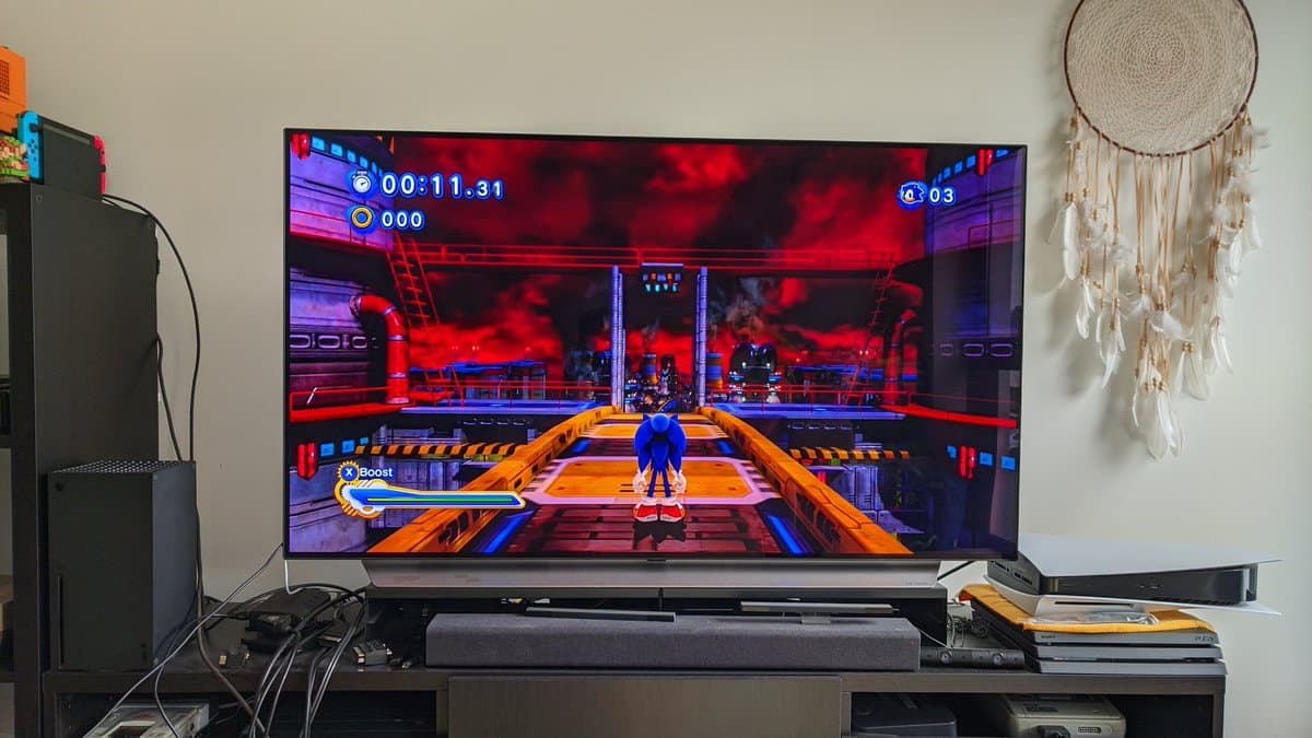 Xbox 360 S running Sonic Generations after PSU recap and joint reflow repair work, displaying gameplay on TV.