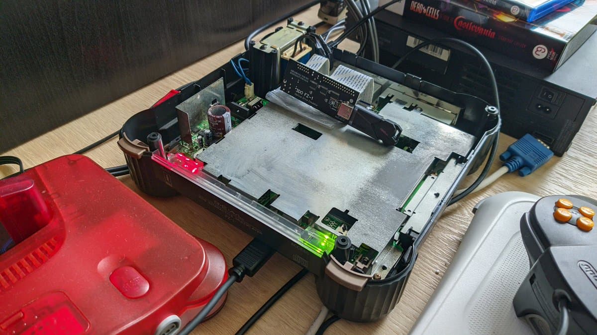 Panasonic FZ-1 mainboard with fresh capacitors, visible reflowed solder joints, and green ODE board installed during restoration.