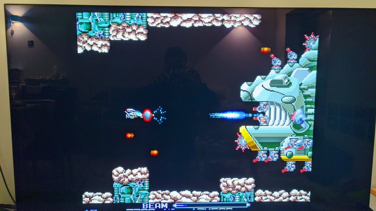Sharp X68000 Pro II displaying R-Type arcade game in-game footage; restored system running successfully after capacitor and transistor repairs.