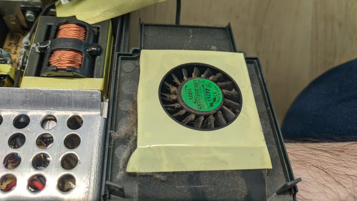 Xbox 360 disc drive with green label fan and copper wire coils visible during laser replacement repair.