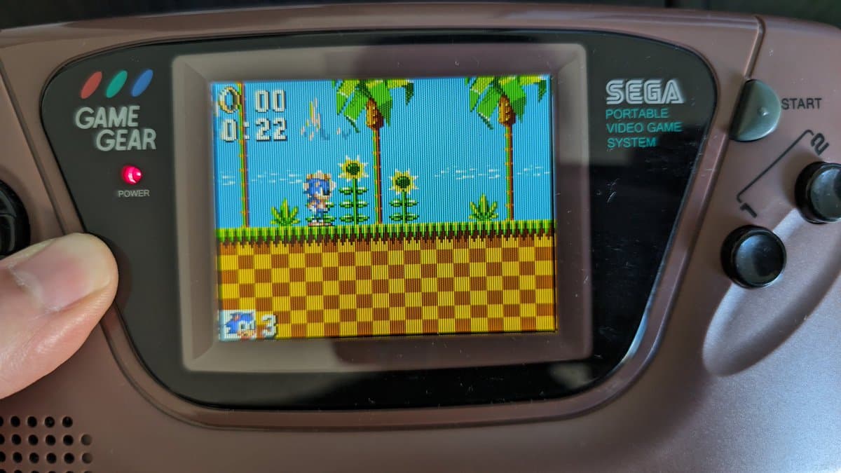 Sega Game Gear displaying Sonic the Hedgehog with restored IPS screen, showing vibrant colors, scanlines, and proper scaling after flex cable repair.