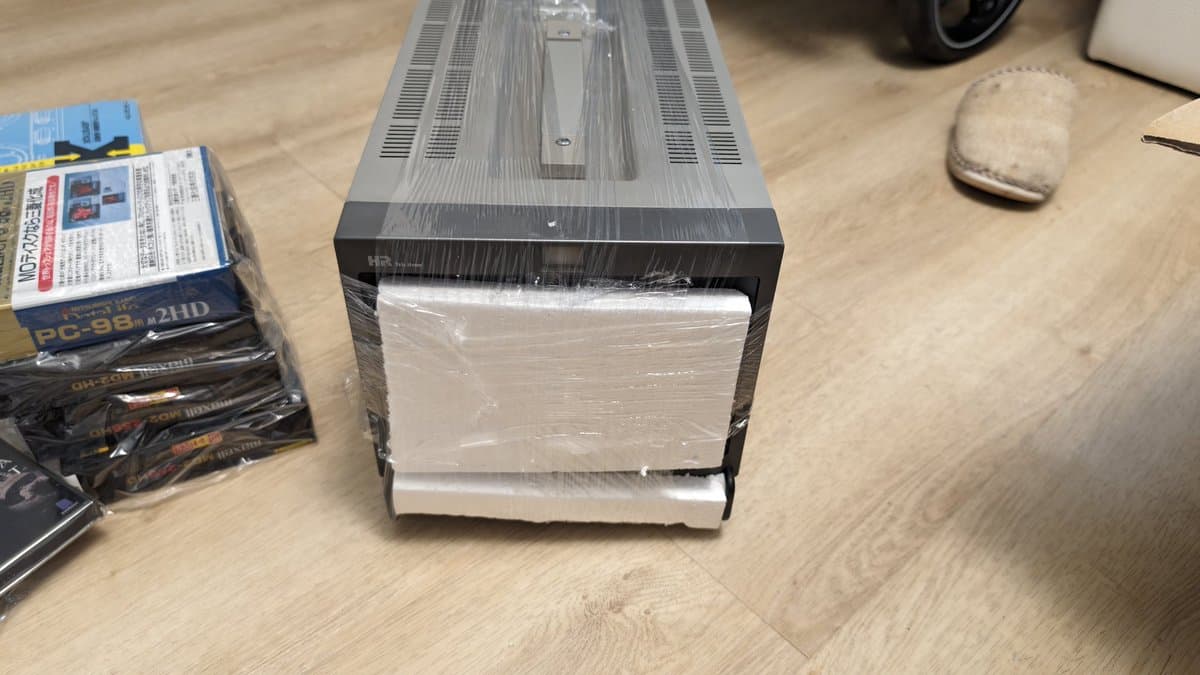 Sony PVM-9045QD CRT monitor wrapped in plastic, front view showing dust accumulation and age-related deterioration during restoration.