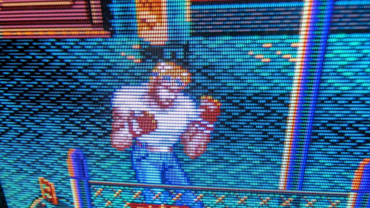 Close-up of PVM-9045QD displaying Streets of Rage 2 from Sega Nomad; visible scan lines and RGB pixel structure show restored deflection board functioning properly.