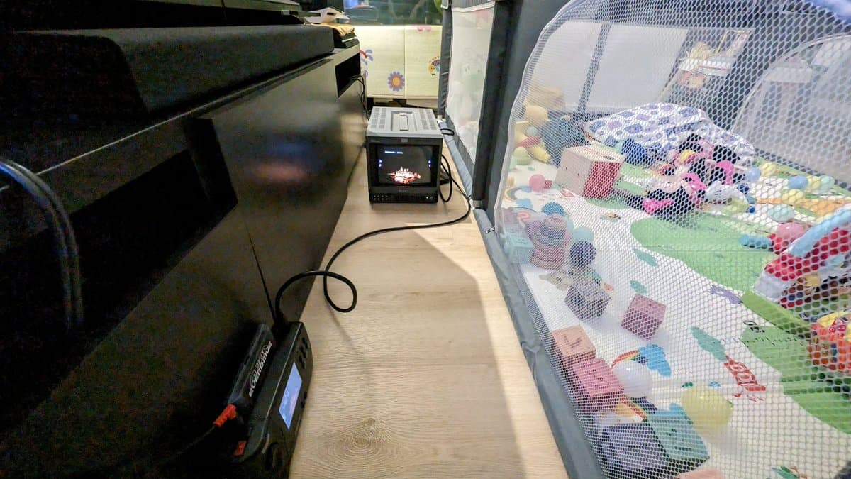 Sony PVM-9045QD CRT displaying Streets of Rage 2 via Sega Nomad after restoration; test equipment and colorful test pattern visible on adjacent screen.